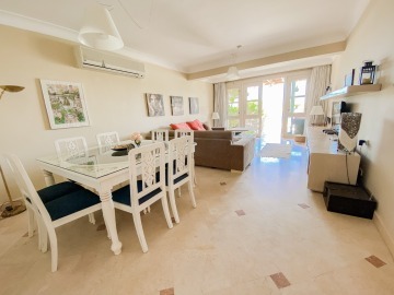 Cozy living - dining room with large sofa and access to the terrace