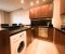 Fully equipped kitchen with a washing machine, dishwasher, kettle, coffee machine, and toaster