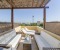 Private roof terrace with sun loungers and shaded seating area.