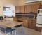 Kitchen with open window to the living room