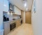 Kitchen with Nespresso maschine, kettle, microwave, cooker and oven. 