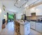 Open kitchen with dining counter, living room and work space 