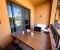 Balcony with seating area, dining table, and a view of the pool