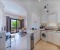 Open kitchen connected to the living room and access to the balcony