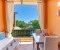 Balcony with seating area, dining table, and a view of the pool