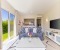 Living room with large TV, open kitchen and dining counter  