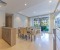 Open kitchen with counter, large dining table, bright living room with access to terrace and pool