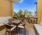 Balcony to the pool side, with table and chairs, plus benches