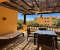 Large balcony with table, chairs and sun lounger