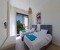 Bedroom 3 with two comfortable single beds, a wardrobe, and a bench