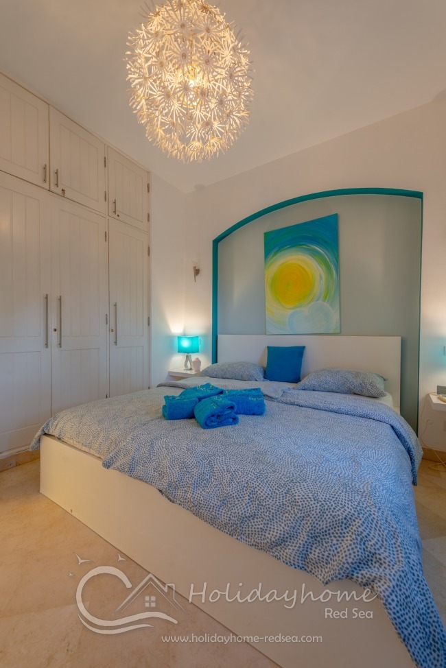 Bedroom with double bed and wardrobe