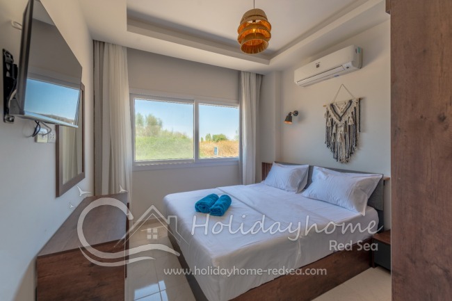 Bedroom with double bed and smart TV