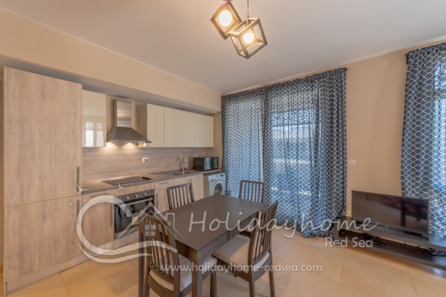 Living room and open kitchen with access to balcony