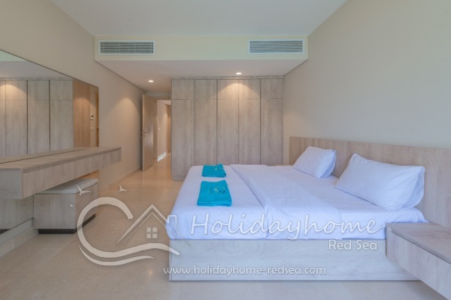 Bedroom with large closet and large mirror