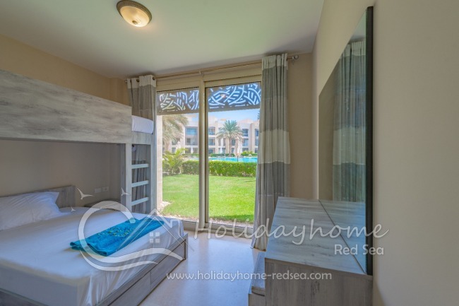 Second bedroom with double bed and pool view