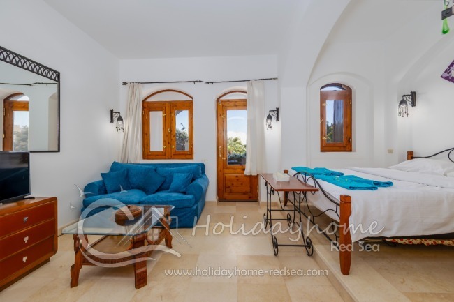 Living/ bed room with sofa and access to terrace