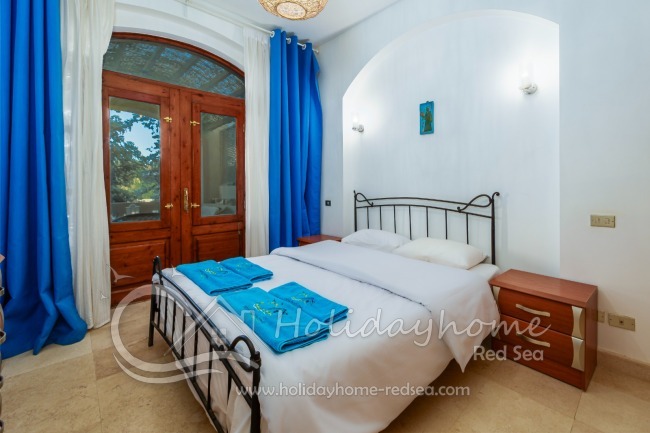 Bedroom 1 with double bed and access to terrace