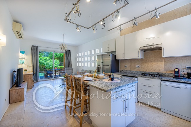 Open kitchen with dining counter, living room and work space