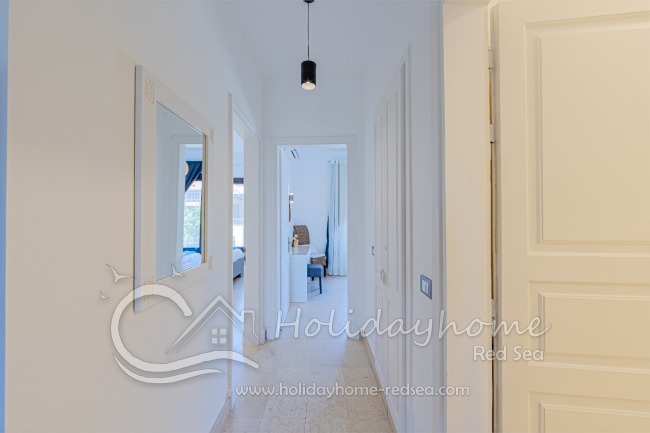 Beautiful hallway with mirror leading to the bedrooms.