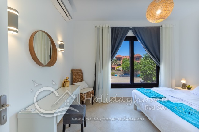 Bedroom 2 with a built-in workspace and a king-size bed (1.8m wide)