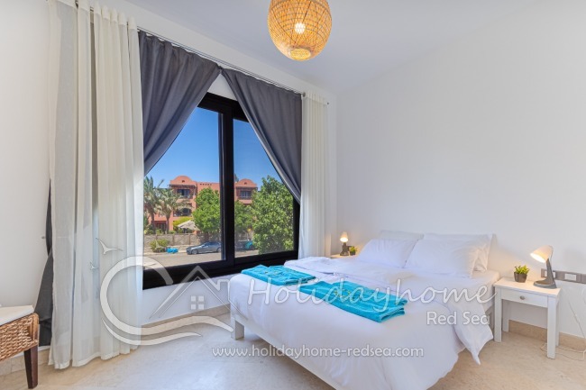 Bedroom 2 with a dedicated workspace and mirror