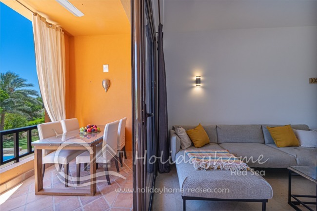 Balcony with seating area, dining table, and a view of the pool