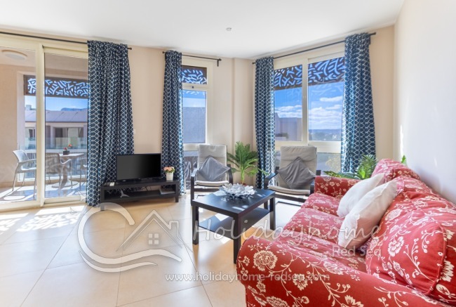 Living room with TV and balcony 