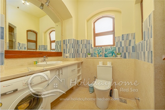 Bathroom with shower and washing machine