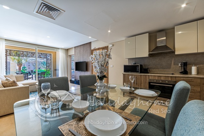Dining area, open kitchen and living room with balcony