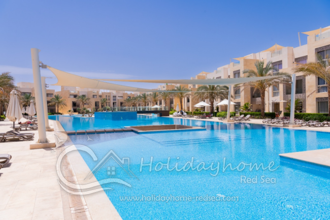 Pool with sunbeds and umbrellas 