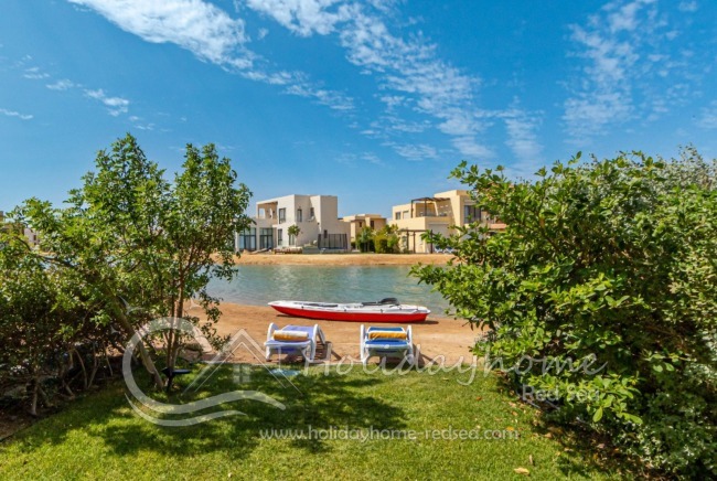 Two sun loungers for relaxing by the lagoon and a kayak available for your use